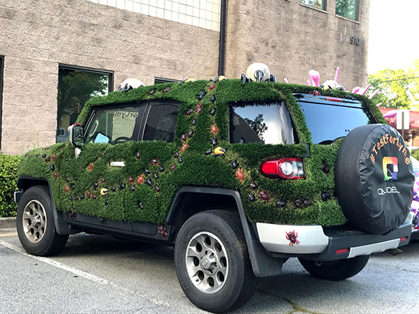 Creative car wraps of insects and grass in Atlanta